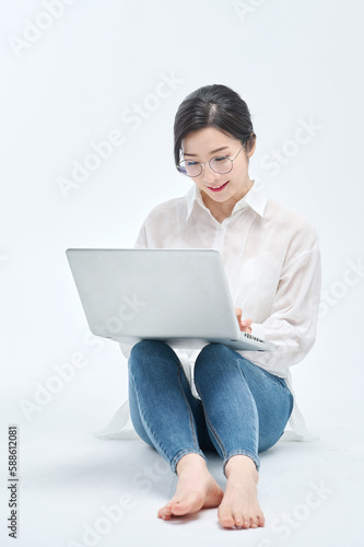 beautiful woman using a laptop on a white background