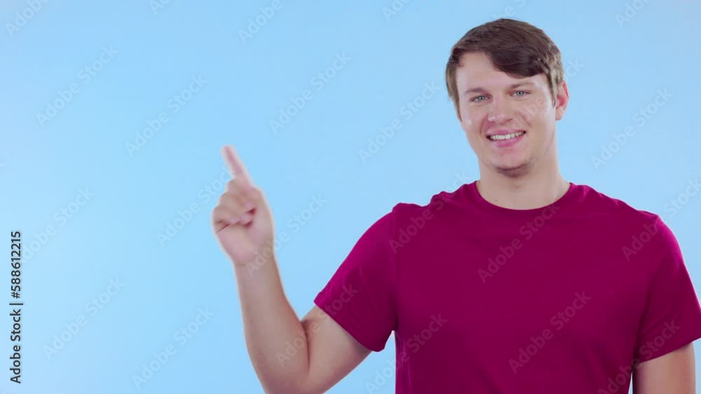 Happy, mockup and face of a man pointing isolated on a blue background in a studio. Smile, advertising and portrait of a guy with a gesture to mock up space for branding, marketing or promotion Happy, mockup and face of a man pointing isolated on a blue background in a studio. Smile, advertising and portrait of a guy with a gesture to mock up space for branding, marketing or promotion