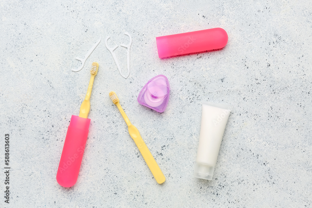 Dental floss, toothpicks, brushes and tube of toothpaste on white grunge background Dental floss, toothpicks, brushes and tube of toothpaste on white grunge background