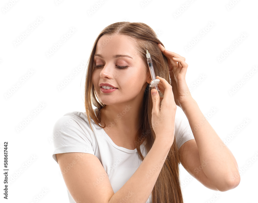 Woman with hair loss problem giving herself injection on white background Woman with hair loss problem giving herself injection on white background