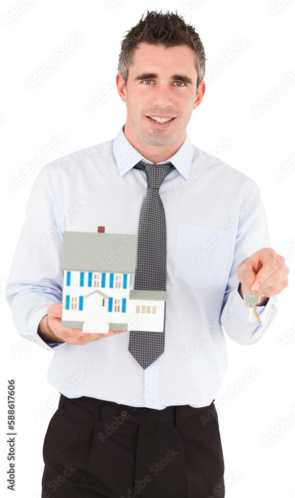 Businessman holding a key and a miniature house Businessman holding a key and a miniature house