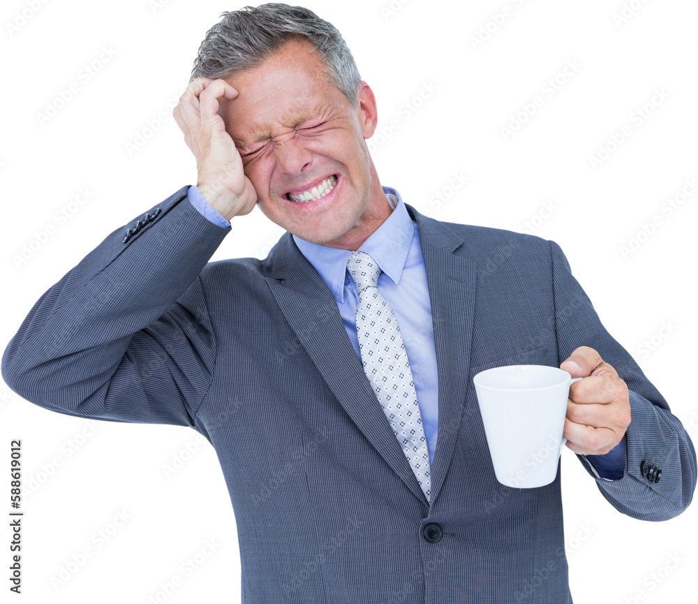 Businessman suffering from headache while holding coffee cup Businessman suffering from headache while holding coffee cup