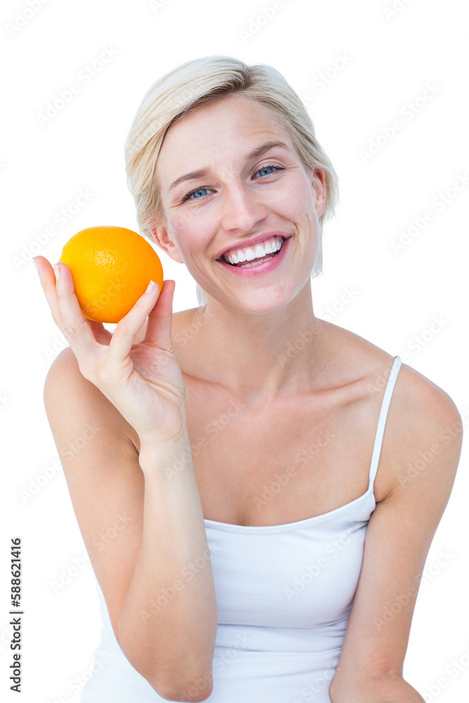 Happy woman holding an orange smiling at camera Happy woman holding an orange smiling at camera