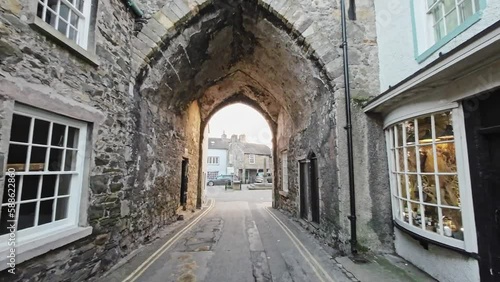 Editorial footage of the Cumbrian Village of Cartmel in the English Lake District. Showing traffic and tourists walking and shopping photo