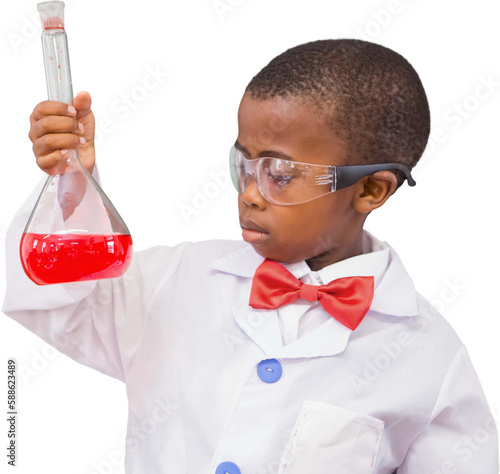 Schoolboy examining red liquid in beaker