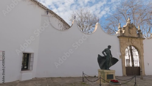 Panning shot of the gate to the Bullring of the Royal Cavalry in Ronda, Spain