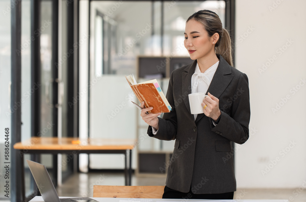 Happy excited young successful asian business woman working at the table in office, Businesswoman and finance marketing. Happy excited young successful asian business woman working at the table in office, Businesswoman and finance marketing.