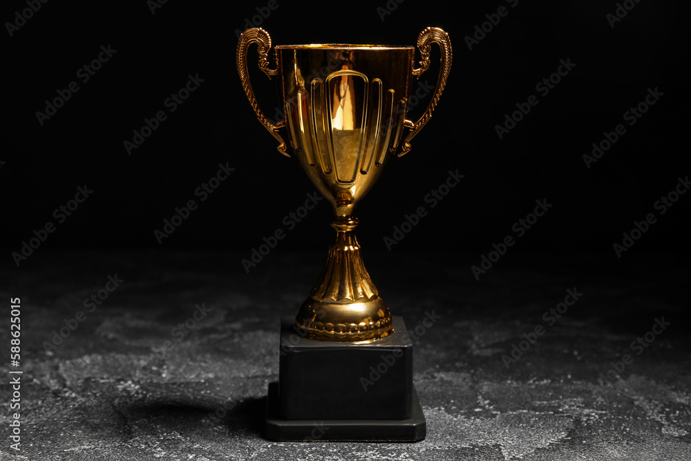 Gold cup on dark background Gold cup on dark background