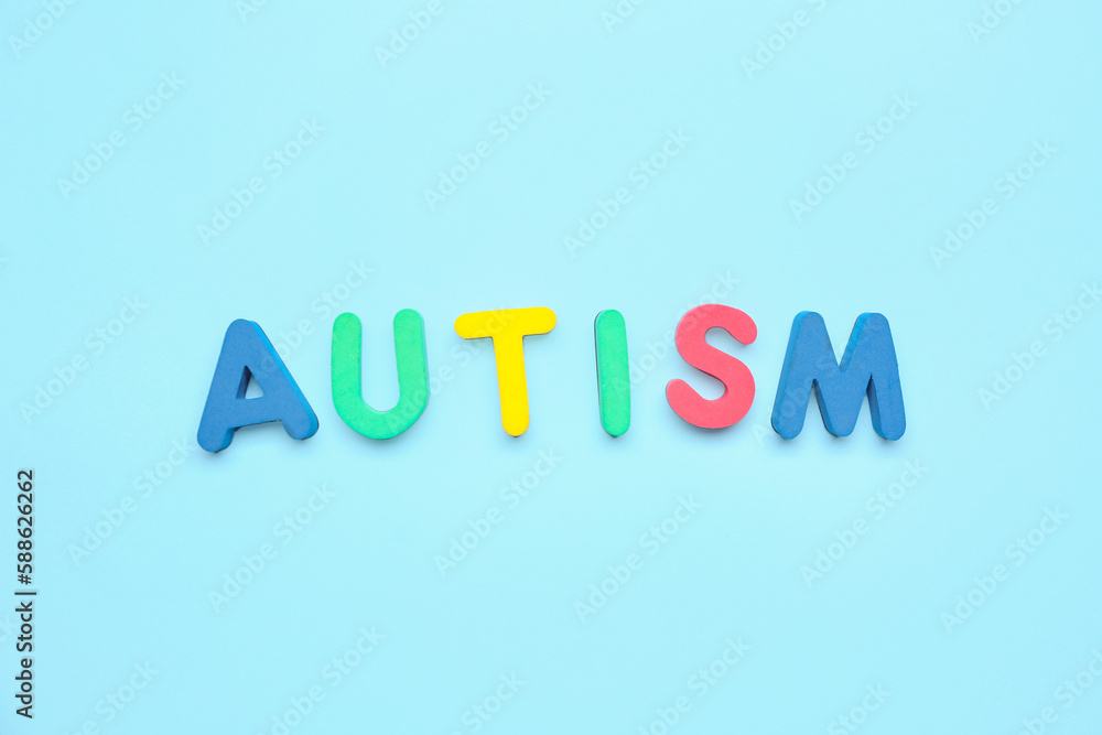Word AUTISM on blue background Word AUTISM on blue background