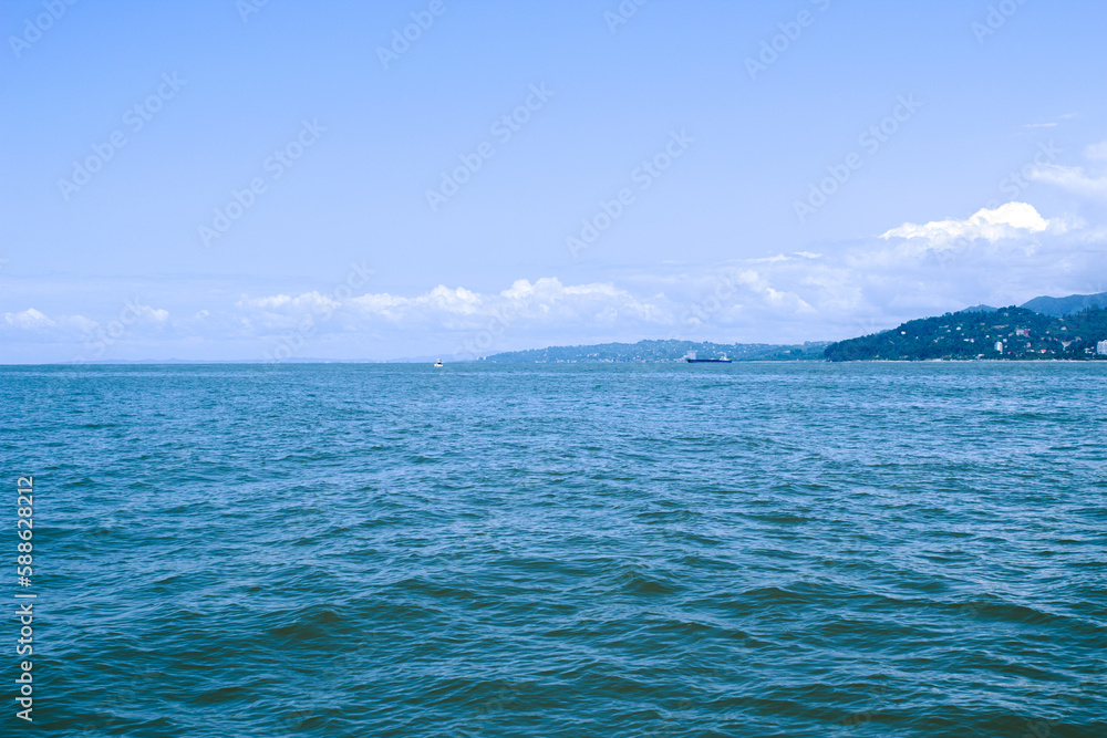 Seascape on a warm sunny day. Beautiful blue sea and island. Seascape on a warm sunny day. Beautiful blue sea and island.