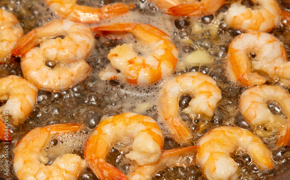 Shrimps are fried in oil in a frying pan Shrimps are fried in oil in a frying pan