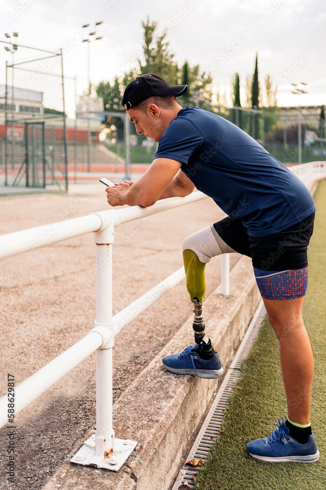 Disabled athlete using phone Disabled athlete using phone