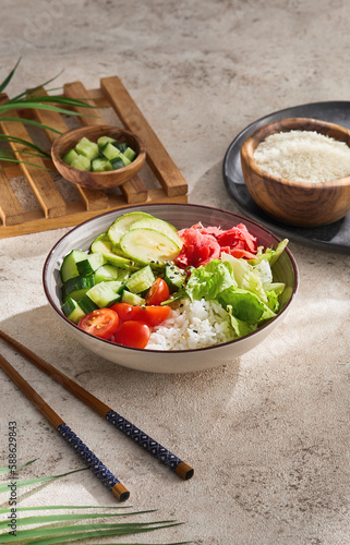 Healthy food - poke bowl with vegetables on light concrete background. Aesthetic composition with veggie bowl in minimal style on beige concrete table. Vegan food menu. Natural food background.