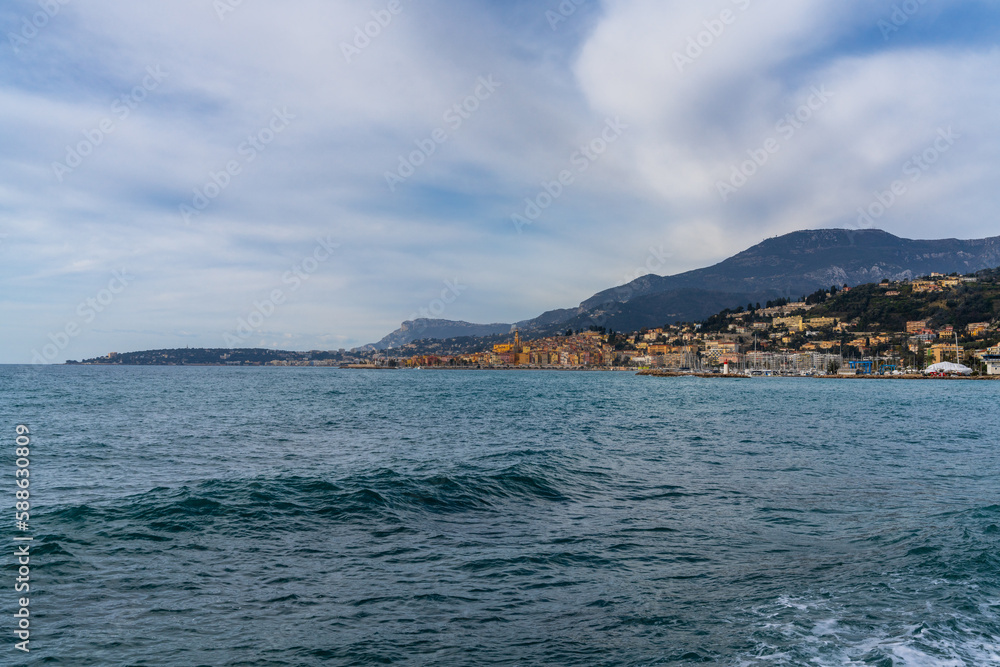 view of the colorful old city center of Menton with the blue Mediterranenan Sea in the foreground view of the colorful old city center of Menton with the blue Mediterranenan Sea in the foreground