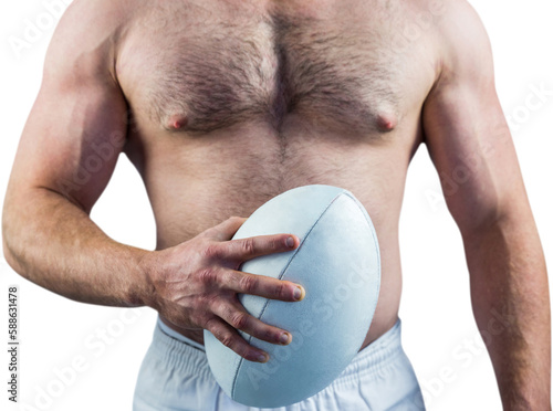 Shirtless rugby player holding ball