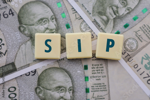 Foto Mutual Fund SIP written on Tiles on Indian Rupee Notes - Systematic Investment P
