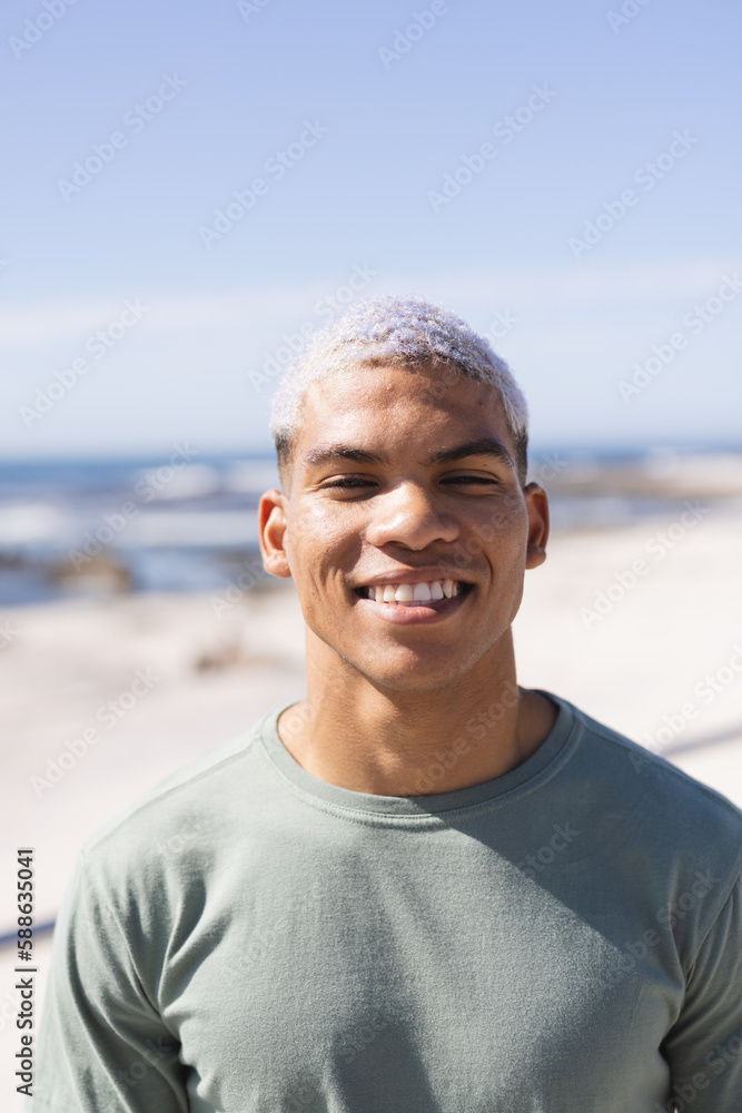 Portrait of happy biracial man looking at camera and smiling at beach Portrait of happy biracial man looking at camera and smiling at beach