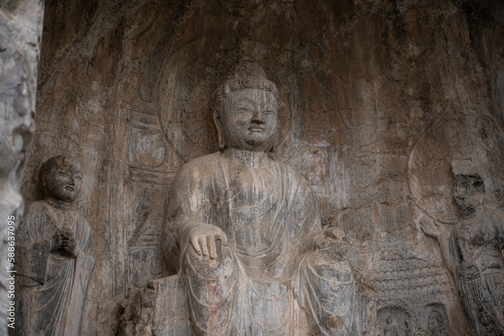 Carved Buddha Limestone at Longmen Grottoes or Caves (Dragon gate Grottoes), The World Heritage Site in Luoyang, Henan province, China. Selective focus