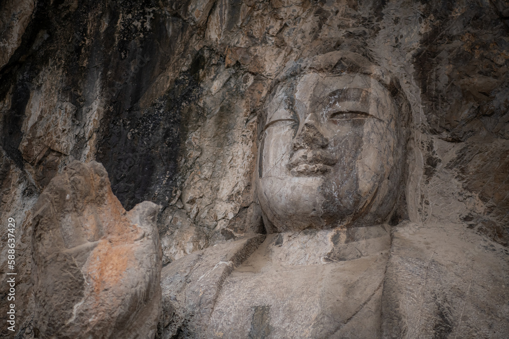 Luoyang The Buddha of Longmen Grottoes in China, close up with copy space for text