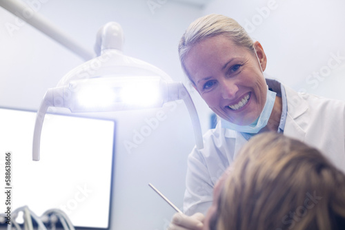 Dentist examining patient with tools