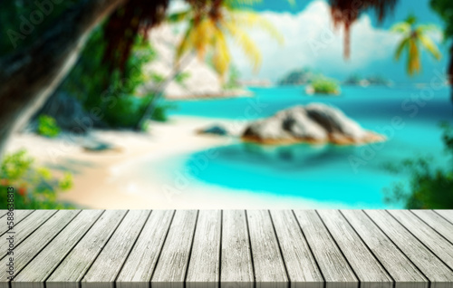 Top of wood table with blurred sea and coconut tree background.