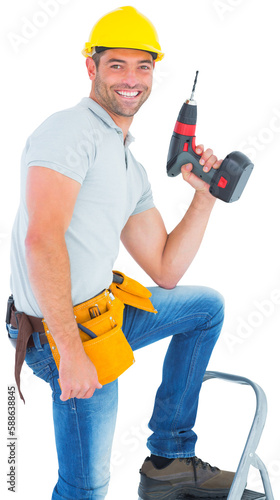 Confident handyman holding power drill while climbing ladder