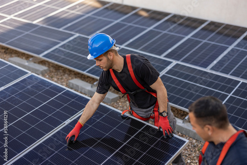 Candid photo of expert solar energy consultant on a roof installing solar panels, green energy and sustainable living, eco solutions, generative ai