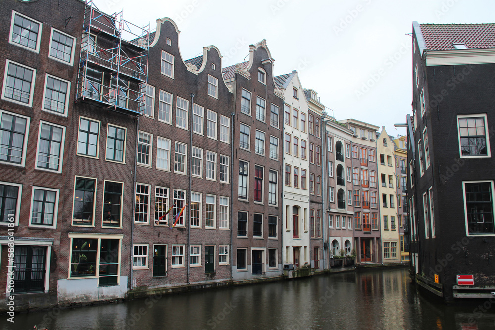 canal and old brick houses in amsterdam (the netherlands) 