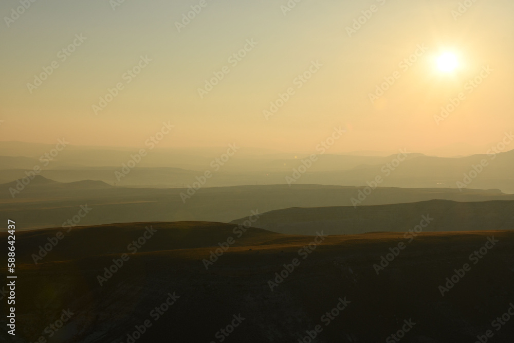Idyllic landscape of hills in fog at sunrise in Cappadocia, Turkey Idyllic landscape of hills in fog at sunrise in Cappadocia, Turkey