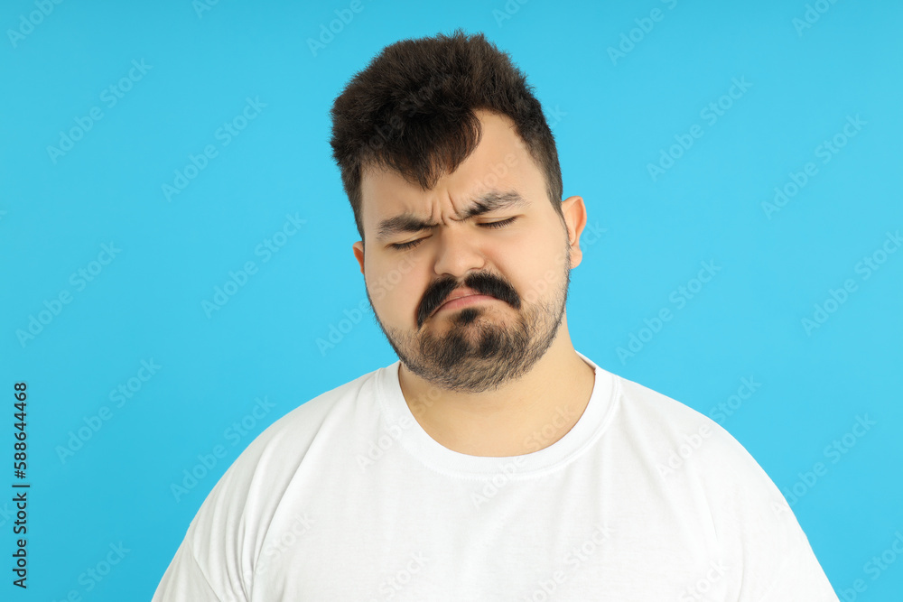 Concept of people, young fat man on blue background Concept of people, young fat man on blue background