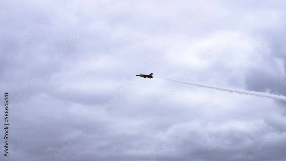 KAI T-50B Jet Plane Leaving White Contrails During Demonstration Flight In Air Show. - tracking KAI T-50B Jet Plane Leaving White Contrails During Demonstration Flight In Air Show. - tracking