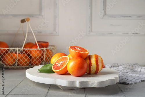 Fototapeta Naklejka Na Ścianę i Meble -  Plate with tasty blood oranges on tile table