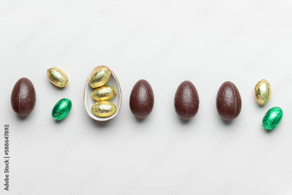 Sweet chocolate Easter eggs and candies on light background Sweet chocolate Easter eggs and candies on light background