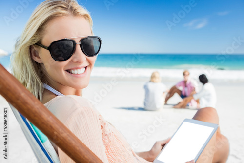 Smiling woman holding digital tablet