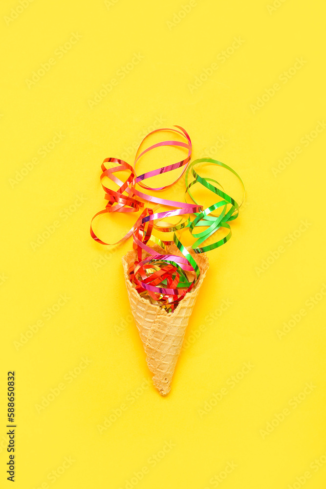 Composition with ice cream cone and confetti on yellow background Composition with ice cream cone and confetti on yellow background