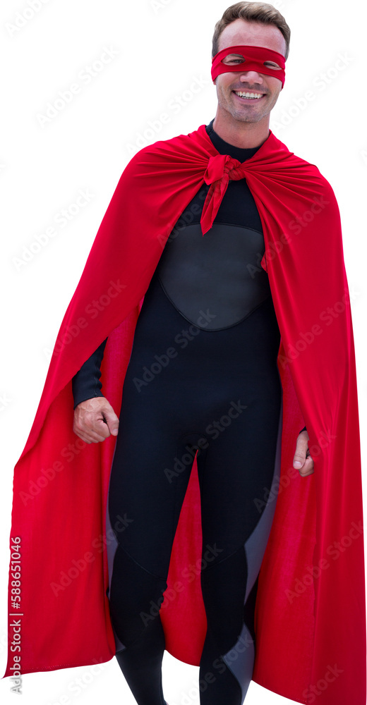 Man in superhero costume walking at sea shore 