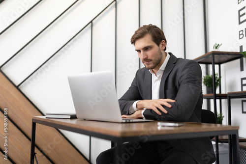 financial analyst with a laptop at work in the office