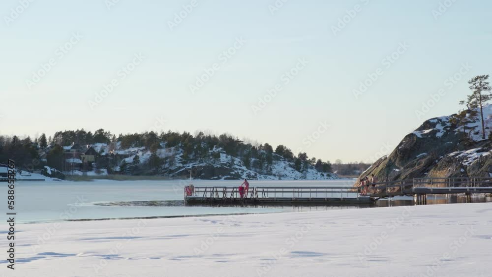 Bunch of ice swimmers going into water on a sunny winter afternoon. Timelapse Bunch of ice swimmers going into water on a sunny winter afternoon. Timelapse