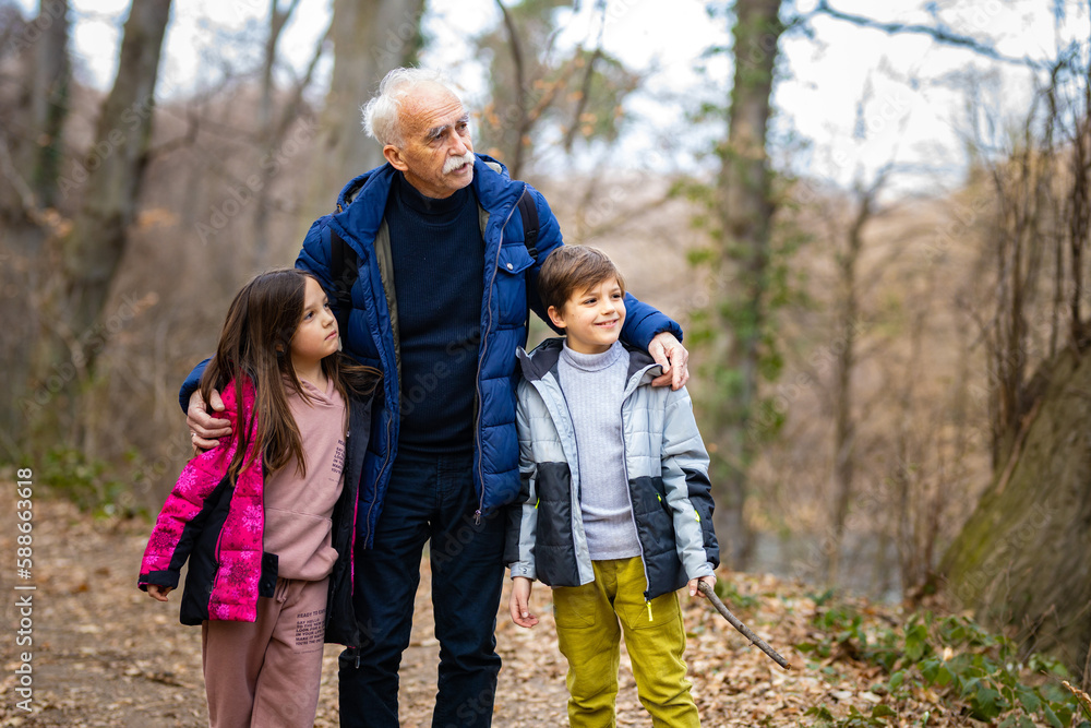 Grandpa walking around the woods with his grandchildren