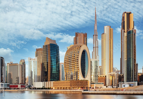 Tableau sur toile Dubai Downtown skyline landscape with reflections in Dubai Creek at sunrise, from Dubai Creek Harbour promenade