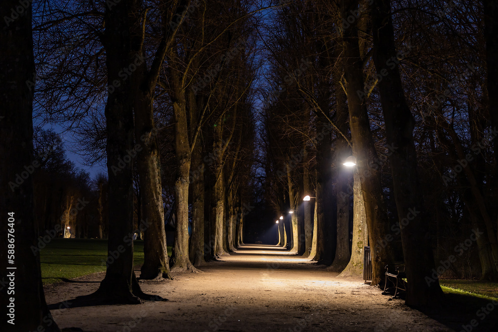 Copenhagen, Denmark An illumninated path at night in the Frederiksberg Have, or Fredewriksberg Gardens.