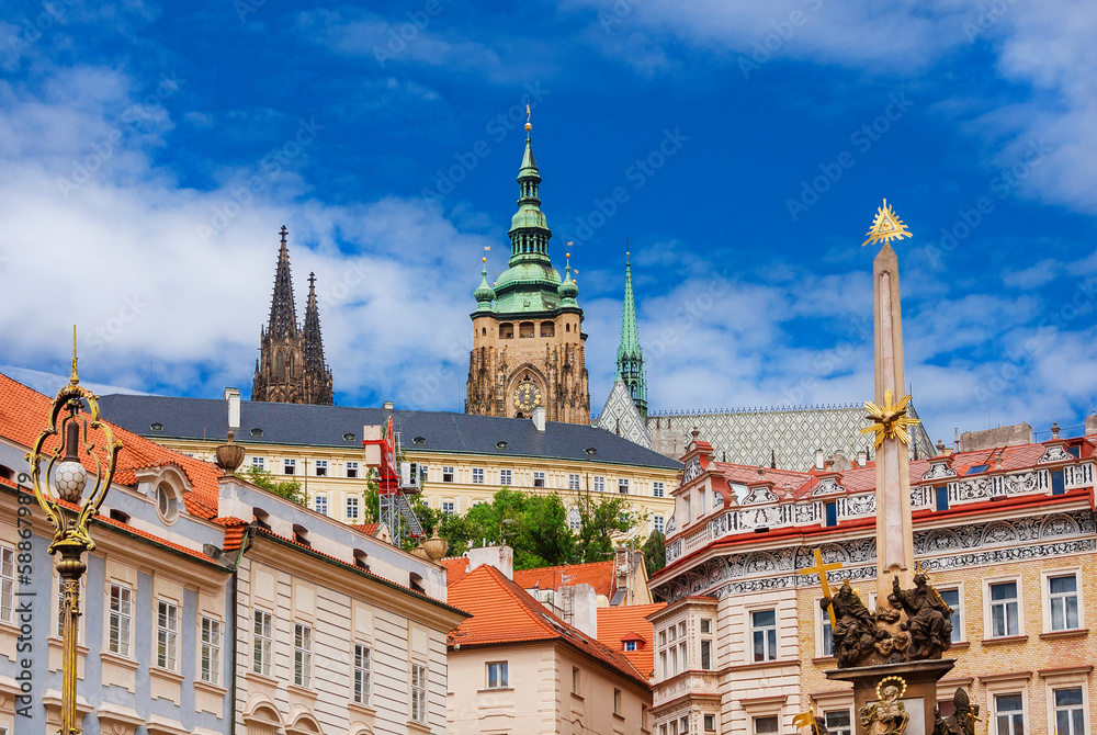 View of Prague historical center with St. Vitus Cathedral beautiful gothic spires and Column of the Holy Trinity from Mala Strana Square