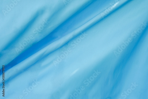 Blue cloth background abstract with soft waves
