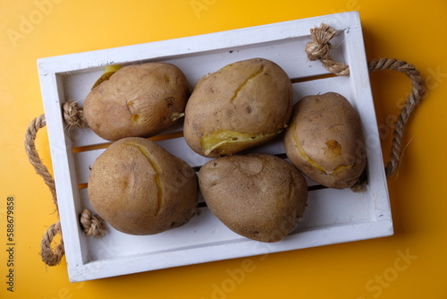 Wallpaper Mural boiled potatoes on a white wooden cutting board. carbohydrate. Torontodigital.ca