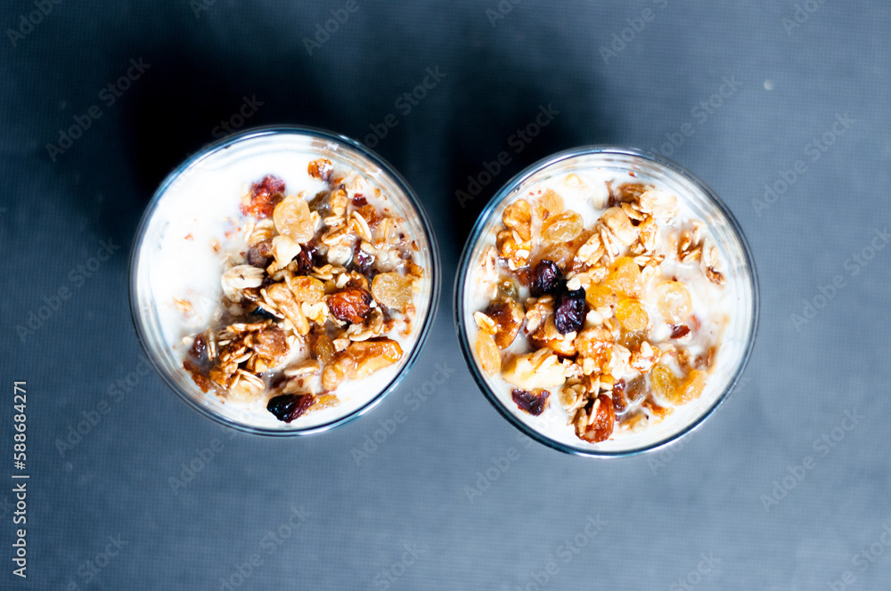 Two plates of muesli with milk on gray background Two plates of muesli with milk on gray background