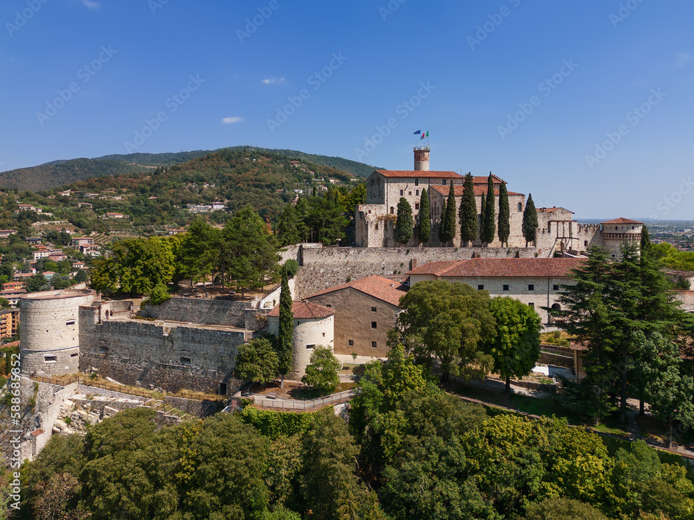 Panoramic drone view of the western part of the historic castle on a hill (colle Cidneo) in the city of Brescia. Lombardy, Italy