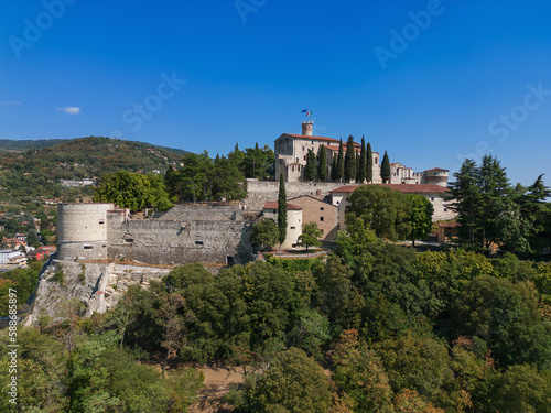 Beautiful view of the old park and the hill (colle Cidneo) with the historic castle on it in Brescia town. Lombardy, Italy photo