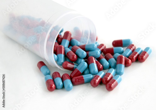 red and blue capsuls of pharmaceutic close up photo