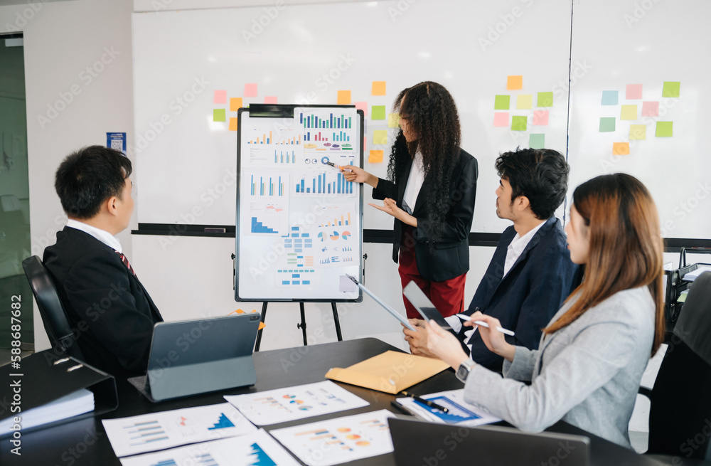 Asian business people sum up the results of their work in the company during the year, new project in office Asian business people sum up the results of their work in the company during the year, new project in office