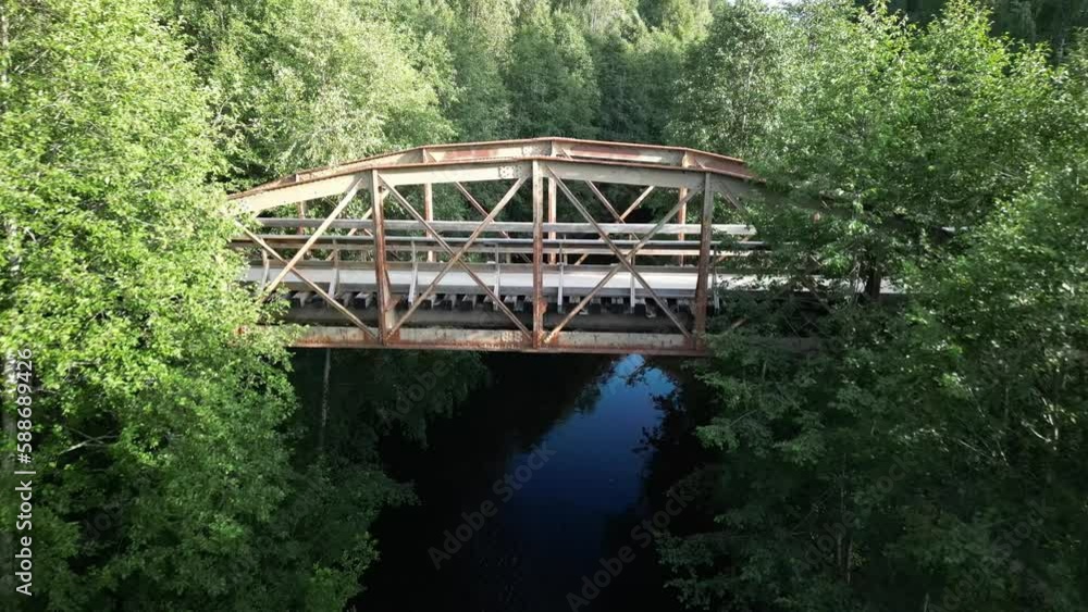 Aerial shot of a bridge above a lake in the woods Aerial shot of a bridge above a lake in the woods